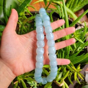 Aquamarine color.  Plastic bead necklace but looks like glass.